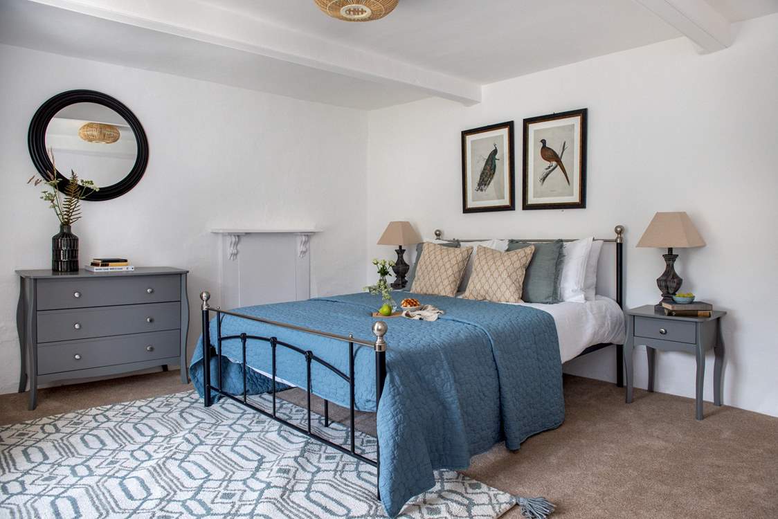 This dreamy bedroom has a king-size bed and gorgeous luxury linens.
