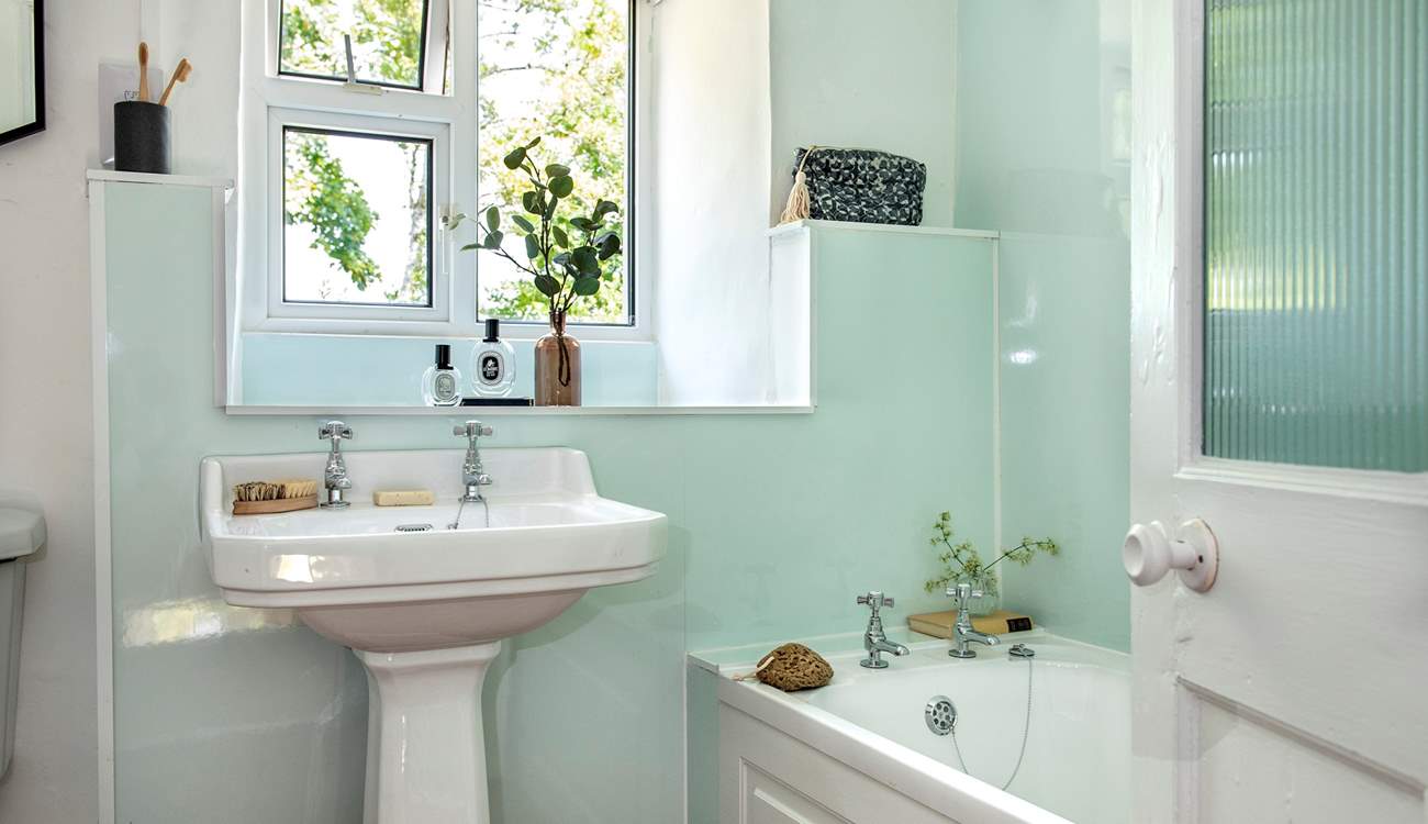 The bathroom on the first floor has a bath for a relaxing soak after a busy day.