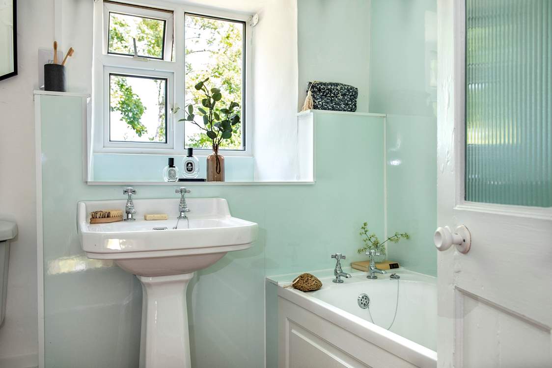 The bathroom on the first floor has a bath for a relaxing soak after a busy day.