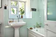 The bathroom on the first floor has a bath for a relaxing soak after a busy day.