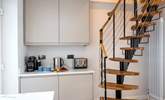 A steep spiral staircase leads up to the first floor bedroom. - Thumbnail Image