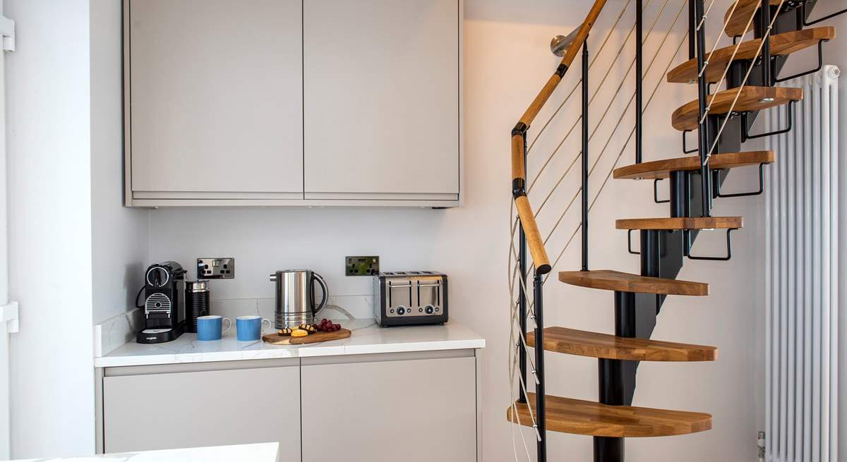 A steep spiral staircase leads up to the first floor bedroom.