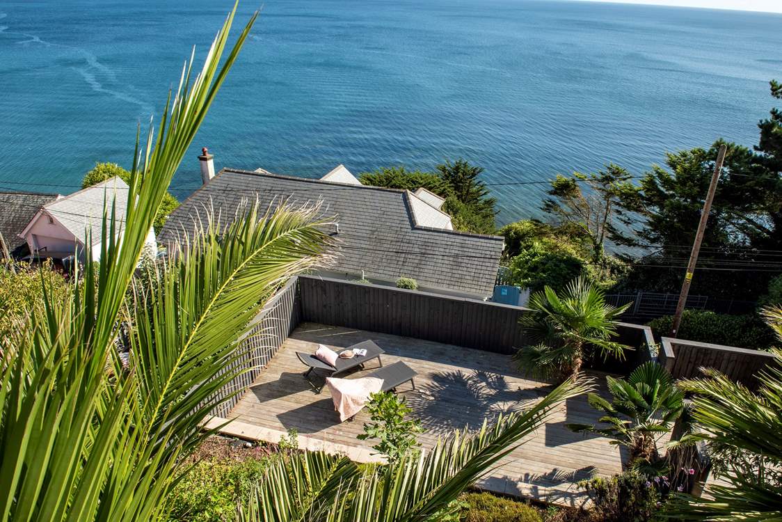 A lower decking area provides a sheltered area to relax and soak up the sun.