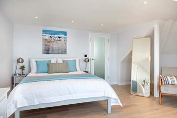 The two bedrooms are beautifully presented in relaxing shades and tones that perfectly complement the setting.