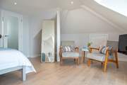The seating area in the second bedroom is the ideal spot to enjoy morning coffee or relaxing with a good book.