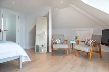 The seating area in the second bedroom is the ideal spot to enjoy morning coffee or relaxing with a good book.