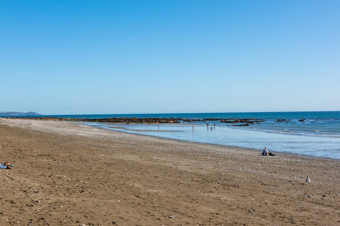 The beach at Seaton, when the tide is out you can walk all the way along the headland to Rame Head.