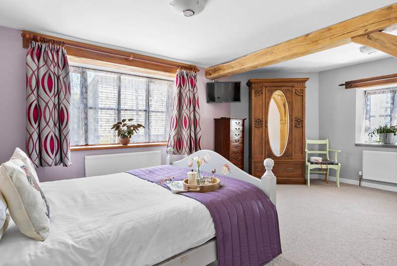 This bedroom is beautifully furnished and even comes complete with its own TV and en suite.