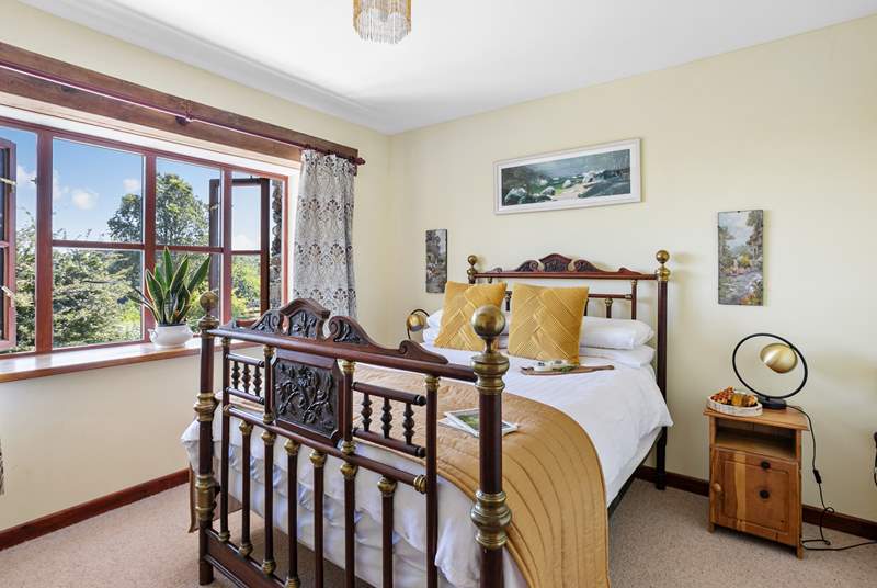 A fantastic double bed sits in the centre of the room with wonderful views down towards the estuary.