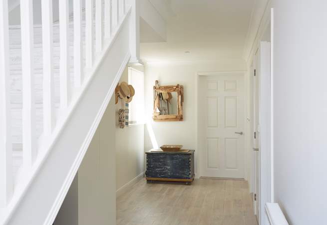 The ground floor entrance hall with bedrooms one and two, and the family bathroom leading off.
