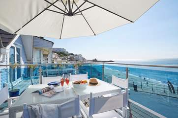 The balcony has a bird's eye view of the beach.