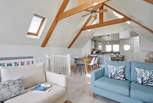 The light and bright living space on the first floor has an apex ceiling and Velux windows to let the light in.