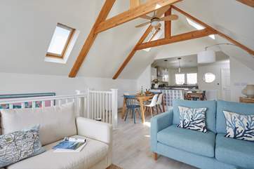 The light and bright living space on the first floor has an apex ceiling and Velux windows to let the light in.