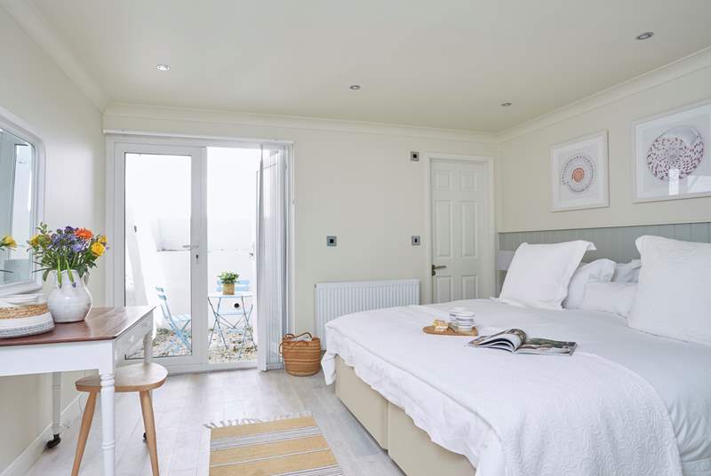 The gorgeous main bedroom (two) on the ground floor has an en suite shower-room and a secluded courtyard, perfect for two.