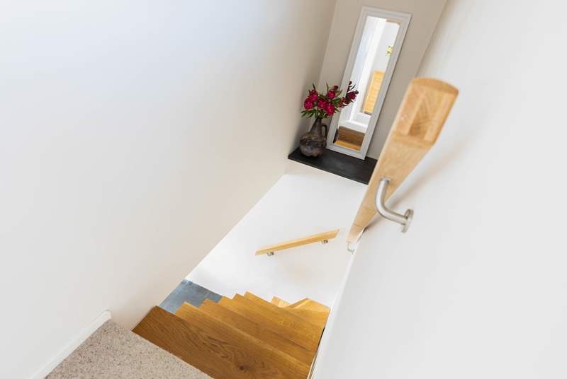 As is usual in traditional Cornish cottages, the stairs are steep and narrow, please take care.  An additional newel post is being added and glass balustrade which are not in place in this image.