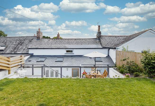 The gorgeous terrace has two sitting areas and leads onto the grassed lawn where the children and family dog can let off steam.