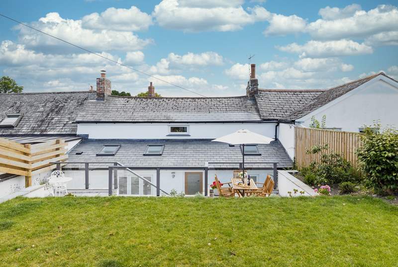 The gorgeous terrace has two sitting areas and leads onto the grassed lawn where the children and family dog can let off steam.