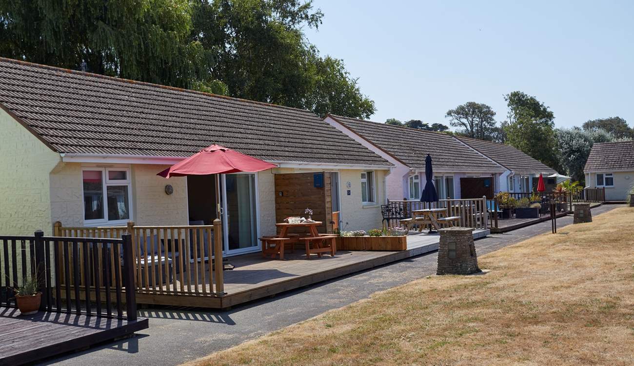 Sugar Beach sits in a row of holiday abodes around a grassed area.