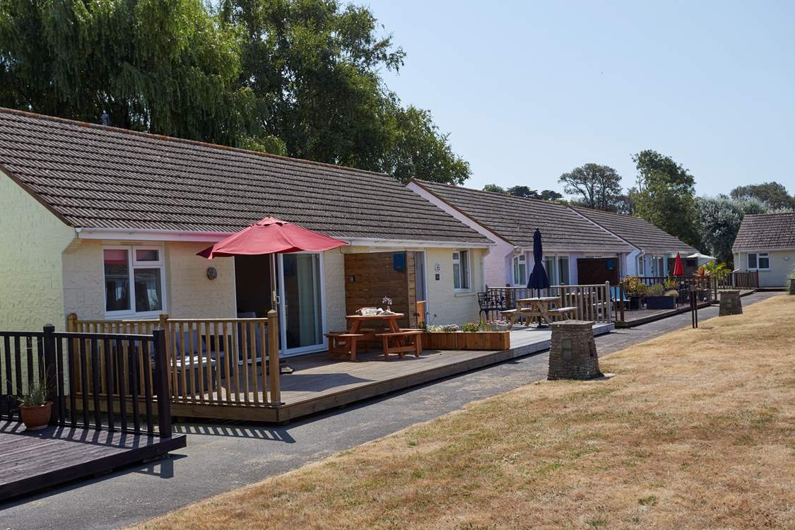 Sugar Beach sits in a row of holiday abodes around a grassed area.