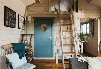 Climb the stairs to find the tucked-away sleeping area.
