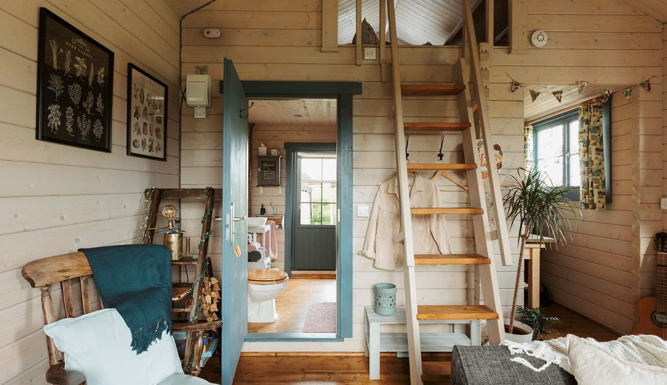 Climb the stairs to find the tucked-away sleeping area.