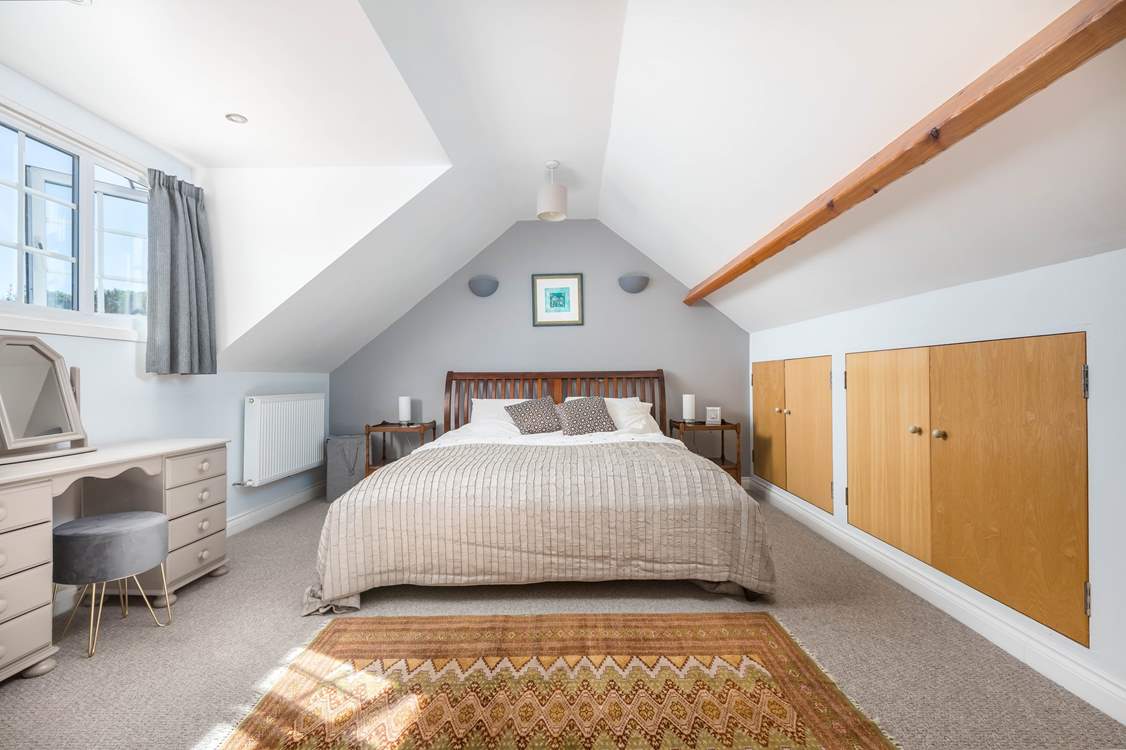 Bedroom one houses a luxurious king-size bed.