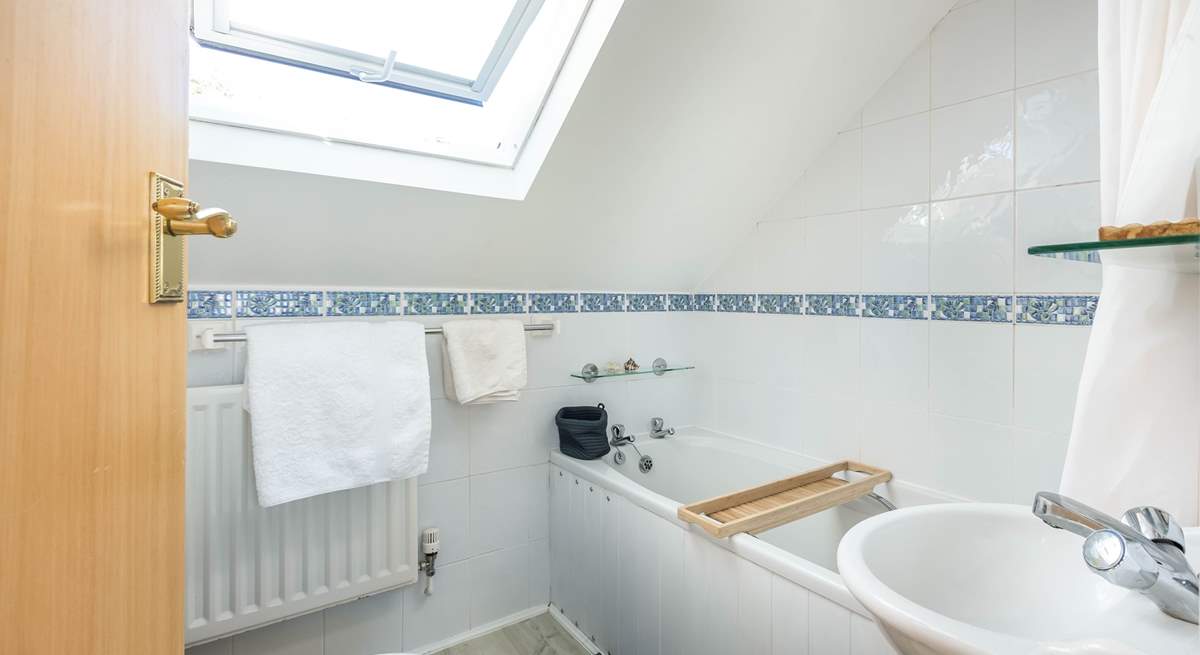 The homely family bathroom makes up the first floor.  Please note the sloping ceilings.