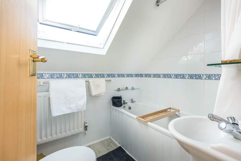 The homely family bathroom makes up the first floor.  Please note the sloping ceilings.