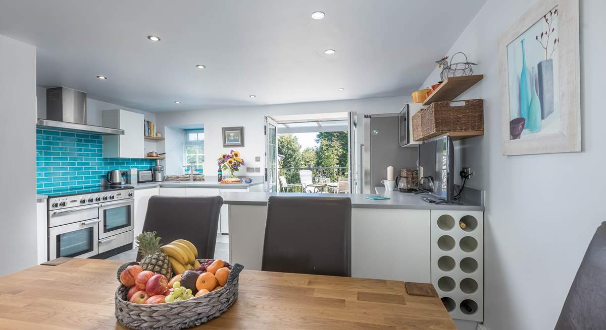 The light and airy kitchen/diner with doors out onto the raised decking area, to the back of the house.