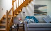 Venture up the open tread wooden staircase to discover the two inviting bedrooms. - Thumbnail Image