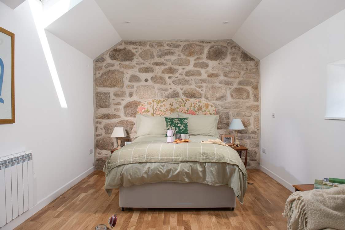 The open plan bedroom is tucked away off the living area.