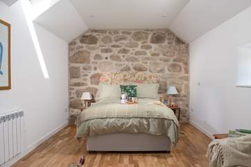 The open plan bedroom is tucked away off the living area.