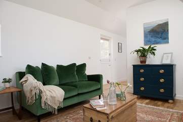 The open plan living space has a super comfy sofa, perfect for relaxing after a busy day.