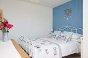 Bedroom 1 is a delightful double room with en suite shower-room. Access to bedroom 1 is via the patio doors, there is no access from inside the house.