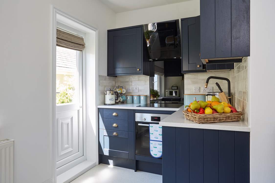 The open plan living space has a lovely kitchen area perfect for cooking those holiday meals.