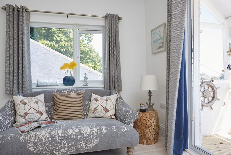 The charming living space has a seaside theme.