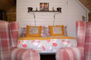The cosy double bed promises a peaceful night's sleep.