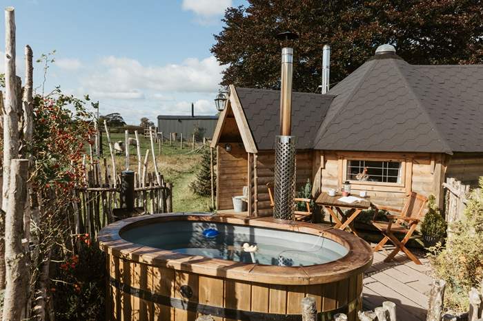 The Woodsman is a Cosy cabin with a wood burner and wood-fired hot tub near Stafford.