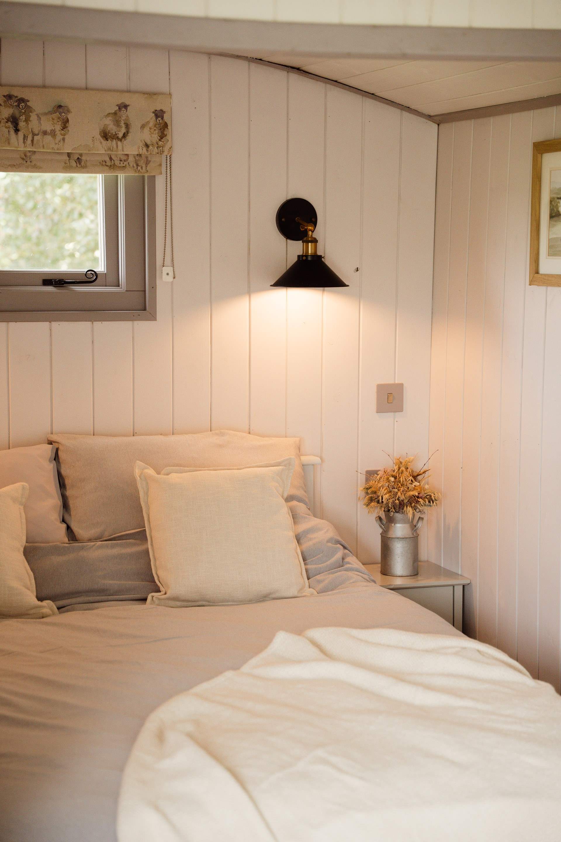 The inviting double bed promises restful nights beneath soft linens.