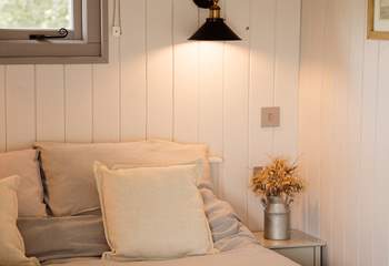 The inviting double bed promises restful nights beneath soft linens.