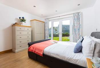 Open the double doors and head out to the sunny garden in bedroom 1.