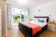 Bedroom 1 is a ground floor king-size room with direct access to the sunny garden.