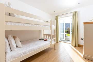 Bedroom 2 has cute bunk-beds and access to the garden.