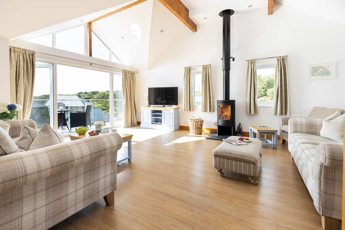 The sitting-room has patio doors which lead out to the south-facing balcony.