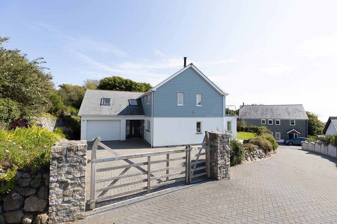 Lowenna House has parking for three cars through the wooden gate.