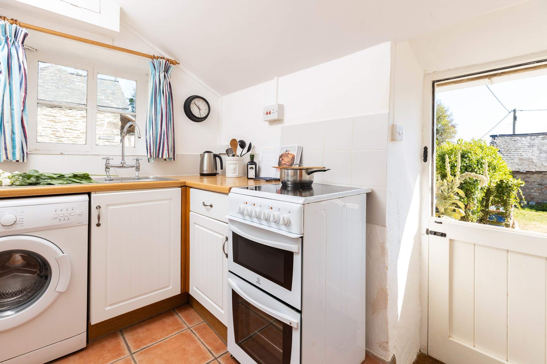 The kitchen opens to the courtyard where you park the car, enjoy listening to the bird song with the stable-door open. 