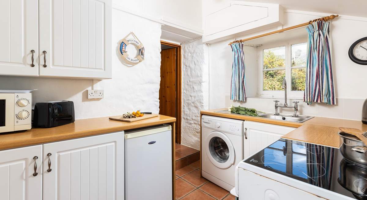 The kitchen leads through to the sitting/dining-room, please watch your head on the steps and low beam in this old cottage. 