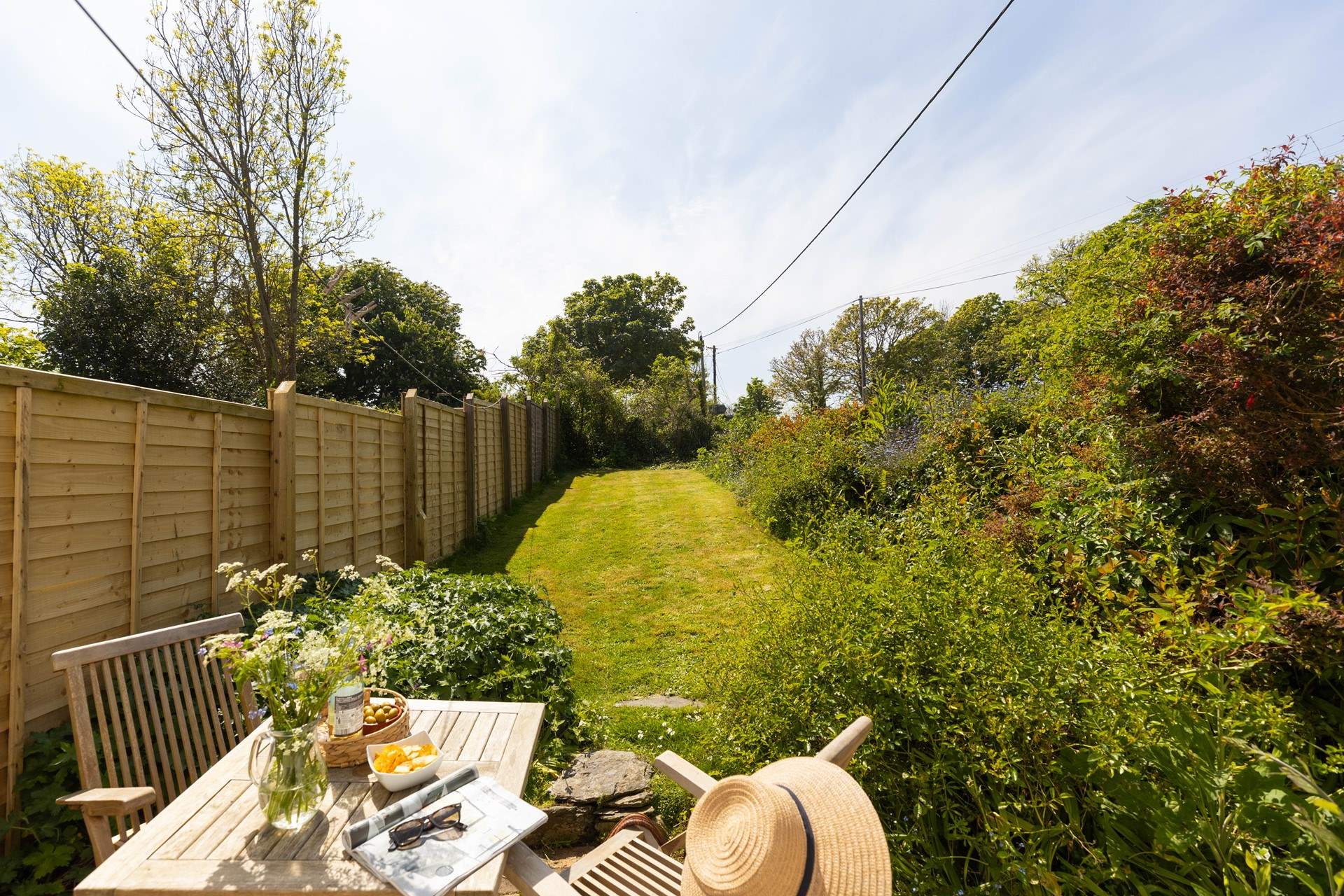 The pretty cottage garden catches the lunch time and  afternoon sun. 
