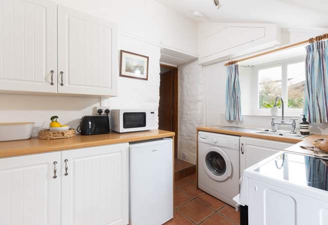 The kitchen leads through to the sitting/dining-room, please watch your head on the steps and low beam in this old cottage. 