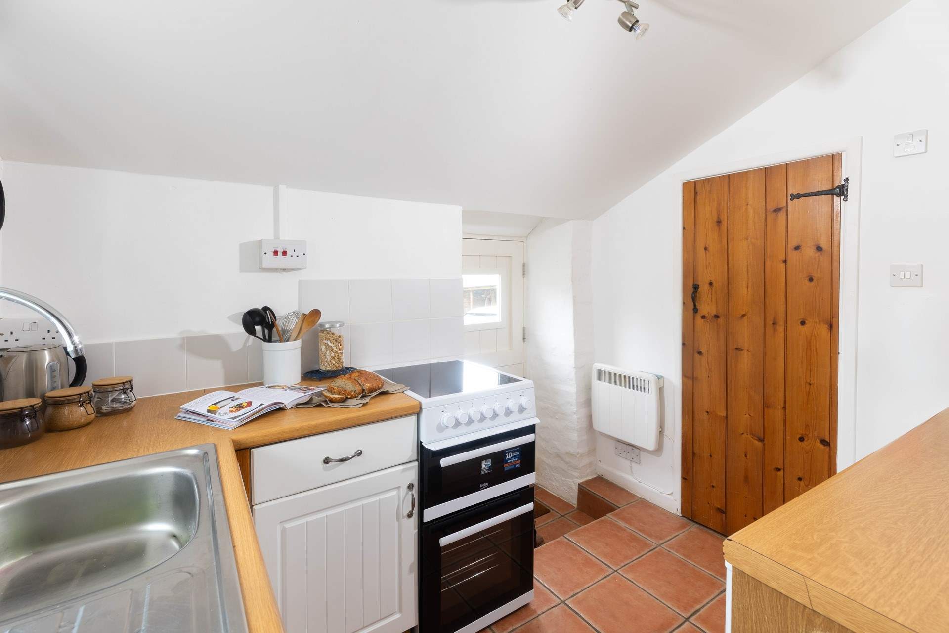 The shower room leads off the kitchen and the stable door leads to the car parking area. 